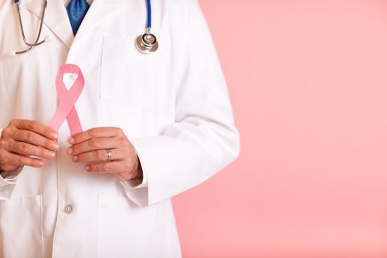 Male Doctor Holding Pink Breast Cancer Awareness Ribbon