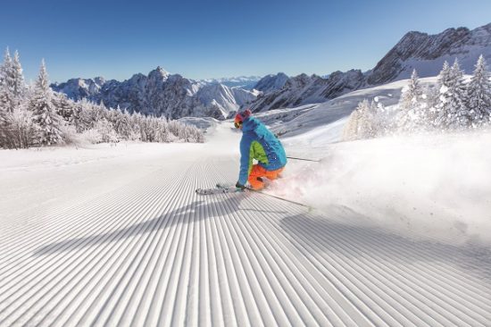 Skier skiing downhill in high mountains