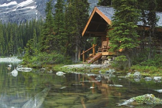 Log cabin hidden in the trees by the Lake Ohara in Canada
