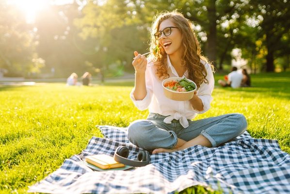 Woman,Enjoying,A,Poke,Bowl,On,A,Sunny,Day,In